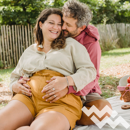 male holding pregnant female belly